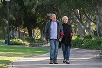 Couple walking through a park. 