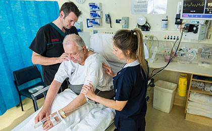 Healthcare workers tending to a patient