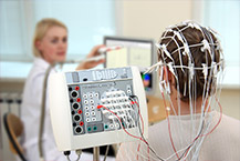Health professional monitoring a patient having an electroencephalograph (EEG)