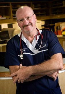 A male nurse with stethoscope hanging around his neck