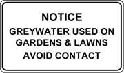 : Image of rectangular sign with black text on white background that states: “Notice. Greywater use on gardens and lawns. Avoid contact.”