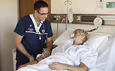 Male nurse attending to patient