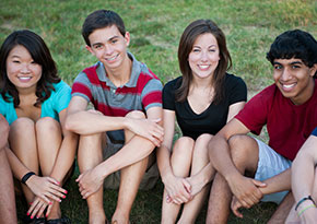 Group of high school students sitting on the grass