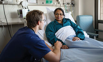 Doctor talking to a patient in a hospital bed